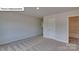 Cozy bedroom featuring neutral walls, carpet, and a doorway leading to an adjacent bathroom at 8067 Kennesaw Dr, Gastonia, NC 28056