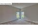 Cozy bedroom with neutral walls and a sunny window view at 8067 Kennesaw Dr, Gastonia, NC 28056