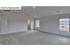 Spacious bedroom with neutral carpet and a view of the yard through two windows at 8067 Kennesaw Dr, Gastonia, NC 28056