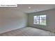 Bedroom with neutral walls, carpet, a view of the yard and a bright, sunny window at 8067 Kennesaw Dr, Gastonia, NC 28056
