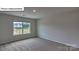 Bedroom with carpet and large window with view of the neighborhood at 8067 Kennesaw Dr, Gastonia, NC 28056