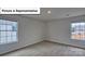 Bright bedroom featuring neutral walls, carpet, and double hung windows offering abundant natural light at 8067 Kennesaw Dr, Gastonia, NC 28056