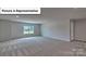Large bonus room with neutral walls, carpet, a window, and a door leading to other parts of the house at 8067 Kennesaw Dr, Gastonia, NC 28056