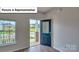 Welcoming entryway with wood-look flooring, an open door to the porch, and a large window at 8067 Kennesaw Dr, Gastonia, NC 28056