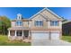 Charming two-story home features a brick-accented front, three-car garage, and covered porch at 8067 Kennesaw Dr, Gastonia, NC 28056