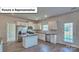 Contemporary kitchen features white cabinets, stainless steel appliances, and a granite island at 8067 Kennesaw Dr, Gastonia, NC 28056
