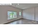 Open living area features stylish wood floors and a large sunny window at 8067 Kennesaw Dr, Gastonia, NC 28056