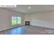 Bright living room features a cozy fireplace, large window and laminate wood flooring at 8067 Kennesaw Dr, Gastonia, NC 28056