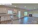 Bright living space showcasing white cabinetry, stainless appliances, and a cozy fireplace at 8067 Kennesaw Dr, Gastonia, NC 28056
