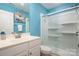 Bright bathroom with a modern vanity, walk-in shower, and cheerful blue walls at 969 Copperstone Ln, Fort Mill, SC 29708