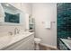 This bathroom features a marble countertop, modern sink, and a shower with unique blue subway tiles at 969 Copperstone Ln, Fort Mill, SC 29708