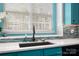 Bright kitchen featuring turquoise cabinets, white countertops, and a modern sink at 969 Copperstone Ln, Fort Mill, SC 29708