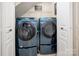 Well-lit laundry room featuring a front load washer and dryer set, and a wire rack shelf for storage at 969 Copperstone Ln, Fort Mill, SC 29708