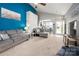 Open-concept living room with an archway, gray sofas, neutral carpet, and access to the outdoors at 969 Copperstone Ln, Fort Mill, SC 29708