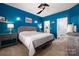 Serene main bedroom with blue walls, modern lighting, carpet, and en-suite bathroom and walk in closet at 969 Copperstone Ln, Fort Mill, SC 29708