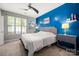Well-lit main bedroom with blue accent wall, bedside tables, carpet, and a ceiling fan at 969 Copperstone Ln, Fort Mill, SC 29708
