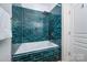 A beautifully tiled shower and bathtub area with rich, blue subway tile at 969 Copperstone Ln, Fort Mill, SC 29708