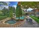 Expansive backyard with a luxurious pool, spa, and serene landscaping, perfect for outdoor enjoyment at 1012 Clover Crest Ln, Weddington, NC 28104