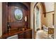 Charming bar area with wood paneling, a round window, and a copper sink at 1012 Clover Crest Ln, Weddington, NC 28104