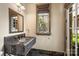 Stylish powder room with ornate mosaic sink and a window offering views of the landscaped exterior at 1012 Clover Crest Ln, Weddington, NC 28104