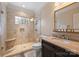Bathroom featuring a large shower with glass door, bench, and single marble vanity at 1012 Clover Crest Ln, Weddington, NC 28104