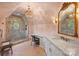 Elegant bathroom featuring a marble shower, a vanity with a marble countertop, and sconce lighting at 1012 Clover Crest Ln, Weddington, NC 28104