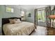 Inviting bedroom with neutral tones, ample natural light, and stylish furnishings at 1012 Clover Crest Ln, Weddington, NC 28104