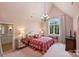 Pretty in pink bedroom with detailed accents, patterned carpet, and large window view at 1012 Clover Crest Ln, Weddington, NC 28104