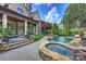 Stately home with well-maintained grounds featuring a pool, spa, and lush landscaping, creating a backyard oasis at 1012 Clover Crest Ln, Weddington, NC 28104