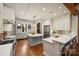 Expansive kitchen with white cabinetry, an oversized island, and stainless steel appliances at 1012 Clover Crest Ln, Weddington, NC 28104