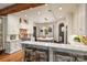 Bright, open kitchen with marble countertops, white cabinets, stainless appliances, and modern lighting at 1012 Clover Crest Ln, Weddington, NC 28104