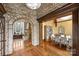 Spacious living room featuring beautiful brick archway, hardwood floors and bright dining room at 1012 Clover Crest Ln, Weddington, NC 28104