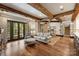 Bright, open living space featuring hardwood floors, exposed beam ceilings, and French doors to the outside at 1012 Clover Crest Ln, Weddington, NC 28104