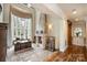 Elegant office featuring a large window, fireplace and stone accents creating a sophisticated workspace at 1012 Clover Crest Ln, Weddington, NC 28104