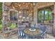 Cozy outdoor stone fireplace with seating area, offering a tranquil spot for relaxation and entertaining at 1012 Clover Crest Ln, Weddington, NC 28104
