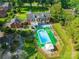 Aerial view of a home with a large pool, expansive backyard, and mature trees, showcasing outdoor living at 1035 Pee Dee Ave, Albemarle, NC 28001