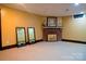 Open basement with a decorative fireplace and carpet, providing a versatile and spacious area for various activities at 1035 Pee Dee Ave, Albemarle, NC 28001