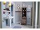 Traditional bathroom with a pedestal sink, gray tiling with red accents, and a rustic wooden storage cabinet at 1035 Pee Dee Ave, Albemarle, NC 28001