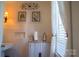 Bathroom with white tile, a cabinet, and natural light, creating a clean and serene environment at 1035 Pee Dee Ave, Albemarle, NC 28001