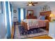 Cozy bedroom with hardwood flooring, floral bedspread, and blue accent curtains at 1035 Pee Dee Ave, Albemarle, NC 28001