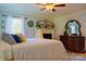 Bedroom featuring a ceiling fan, fireplace, accent decor and plenty of natural light at 1035 Pee Dee Ave, Albemarle, NC 28001