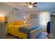 Bright bedroom with yellow accents, decorative pictures, and a ceiling fan, offering a comfortable living space at 1035 Pee Dee Ave, Albemarle, NC 28001