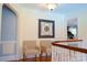 Hallway with neutral walls, hardwood floors, chair-rail and two chairs for seating at 1035 Pee Dee Ave, Albemarle, NC 28001