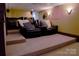 Basement home theater with tiered seating, plush leather chairs, and surround sound for immersive viewing at 1035 Pee Dee Ave, Albemarle, NC 28001