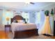Main bedroom with hardwood floors, accent decorations, a queen-sized bed and neutral paint at 1035 Pee Dee Ave, Albemarle, NC 28001