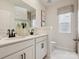 Modern bathroom featuring dual sinks, white cabinetry, and a neutral color palette at 1046 Mapletree Ln, Indian Trail, NC 28079