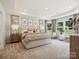 Serene bedroom with plush carpeting, large windows, and tray ceiling at 1046 Mapletree Ln, Indian Trail, NC 28079