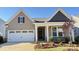 Charming one-story home features a two-car garage and manicured front yard landscaping at 1046 Mapletree Ln, Indian Trail, NC 28079