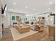 Spacious living room with a fireplace, open floor plan, and natural light at 1046 Mapletree Ln, Indian Trail, NC 28079