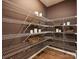 Well-organized walk-in pantry with ample shelving for storage at 1046 Mapletree Ln, Indian Trail, NC 28079